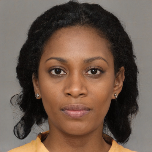 Neutral black young-adult female with medium  brown hair and brown eyes