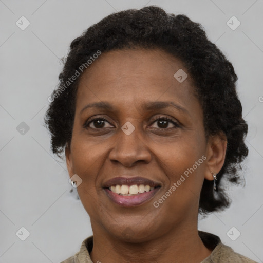 Joyful black adult female with short  brown hair and brown eyes