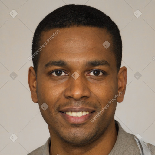 Joyful black young-adult male with short  black hair and brown eyes