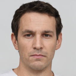 Neutral white young-adult male with short  brown hair and grey eyes