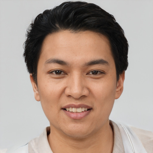 Joyful asian young-adult female with short  black hair and brown eyes
