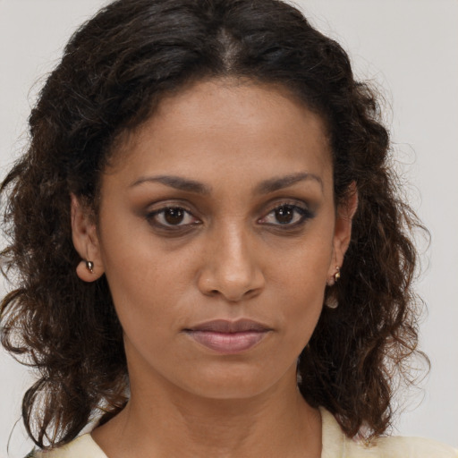 Joyful black young-adult female with medium  brown hair and brown eyes