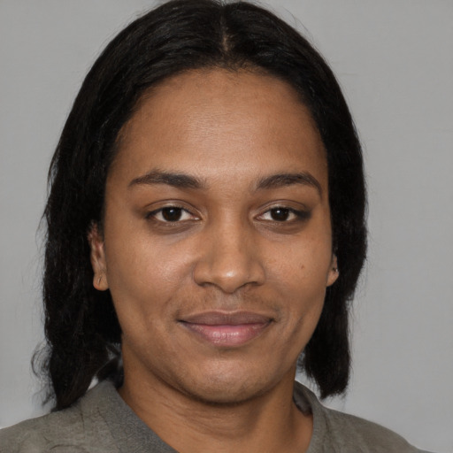 Joyful black young-adult female with medium  black hair and brown eyes