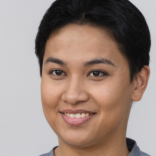 Joyful asian young-adult female with short  brown hair and brown eyes