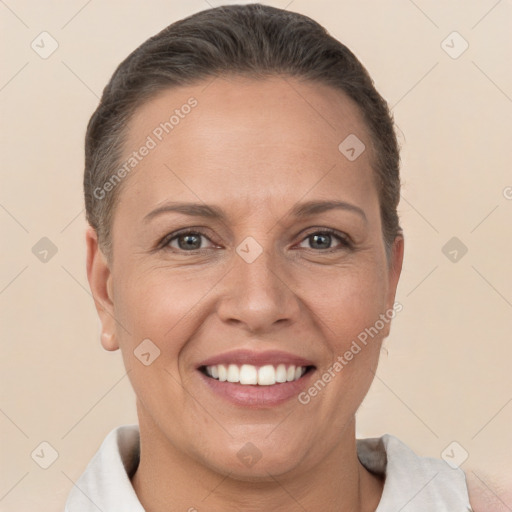 Joyful white adult female with short  brown hair and brown eyes