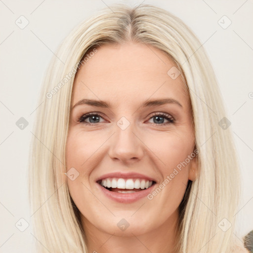 Joyful white young-adult female with long  brown hair and blue eyes