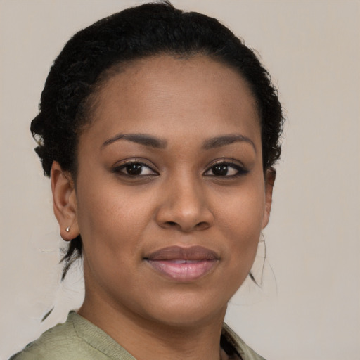 Joyful black young-adult female with short  brown hair and brown eyes