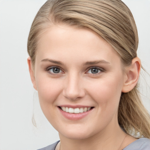 Joyful white young-adult female with medium  brown hair and blue eyes