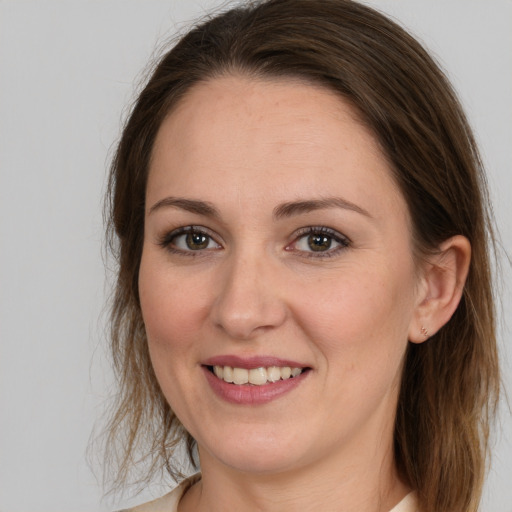 Joyful white young-adult female with medium  brown hair and brown eyes