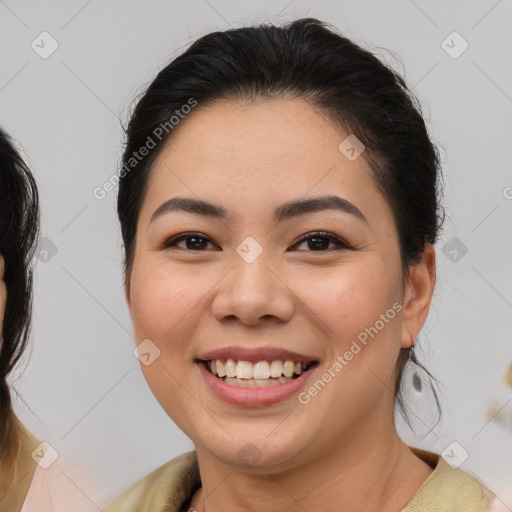 Joyful latino young-adult female with medium  brown hair and brown eyes