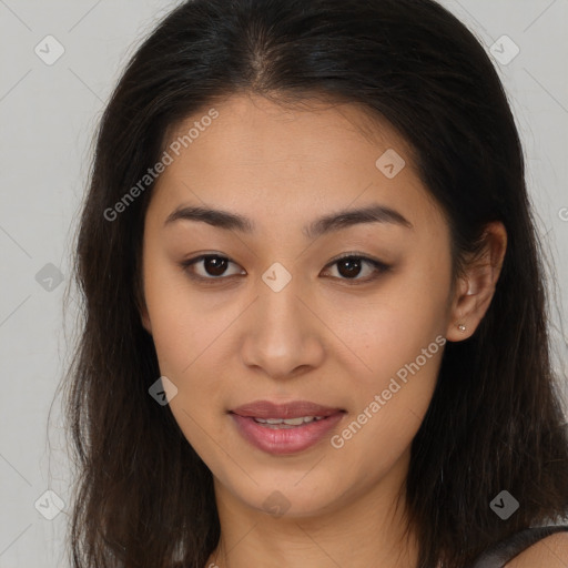 Joyful latino young-adult female with long  brown hair and brown eyes