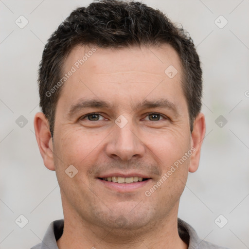 Joyful white adult male with short  brown hair and brown eyes