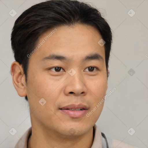 Joyful asian young-adult male with short  brown hair and brown eyes