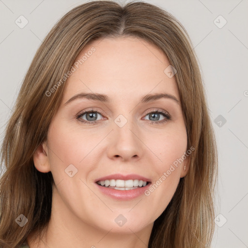 Joyful white young-adult female with long  brown hair and blue eyes