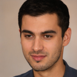 Joyful white young-adult male with short  black hair and brown eyes