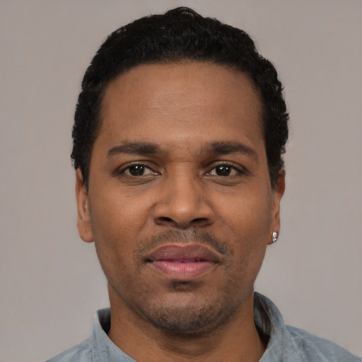 Neutral latino adult male with short  black hair and brown eyes
