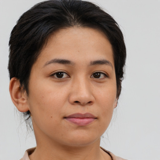 Joyful asian young-adult female with short  brown hair and brown eyes