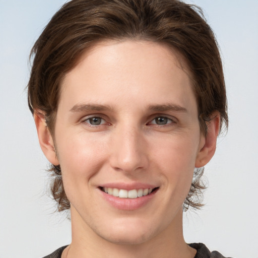 Joyful white young-adult female with short  brown hair and grey eyes