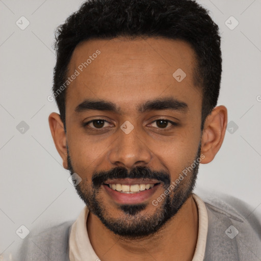 Joyful latino young-adult male with short  black hair and brown eyes