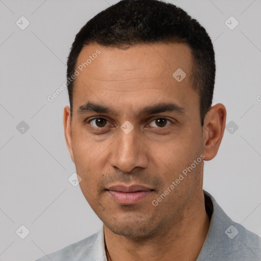 Joyful white young-adult male with short  black hair and brown eyes