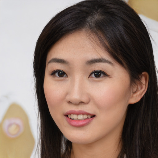 Joyful asian young-adult female with long  brown hair and brown eyes