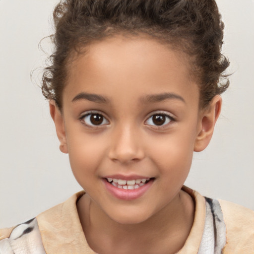 Joyful white child female with short  brown hair and brown eyes