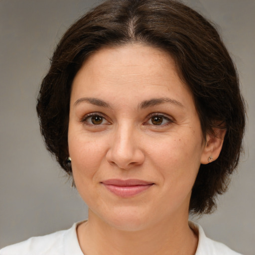 Joyful white adult female with medium  brown hair and brown eyes