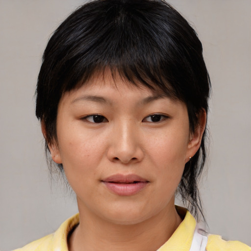 Joyful asian young-adult female with medium  brown hair and brown eyes