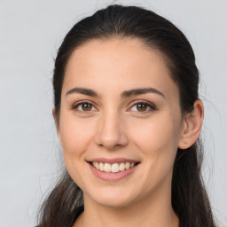 Joyful white young-adult female with long  brown hair and brown eyes