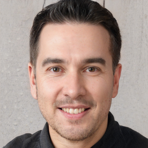 Joyful white young-adult male with short  brown hair and brown eyes