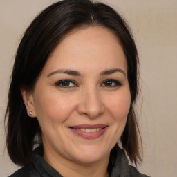 Joyful white adult female with medium  brown hair and brown eyes