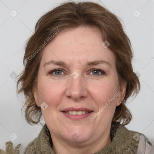 Joyful white adult female with medium  brown hair and grey eyes