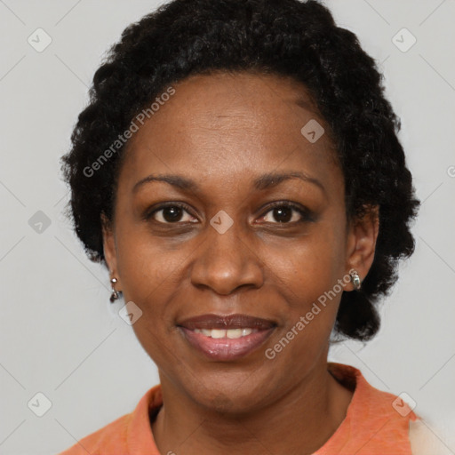 Joyful black adult female with short  black hair and brown eyes