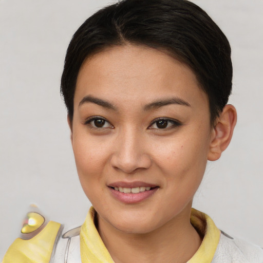 Joyful white young-adult female with short  brown hair and brown eyes