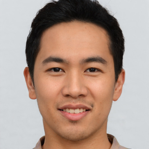 Joyful asian young-adult male with short  brown hair and brown eyes