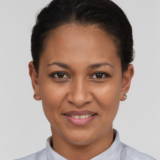 Joyful latino young-adult female with short  brown hair and brown eyes