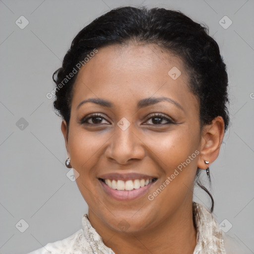 Joyful latino adult female with medium  brown hair and brown eyes