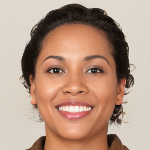 Joyful latino young-adult female with medium  brown hair and brown eyes