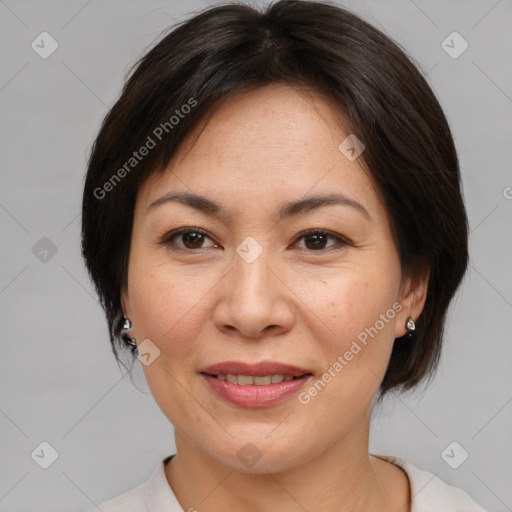 Joyful asian adult female with medium  brown hair and brown eyes