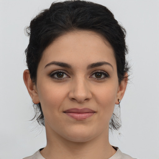 Joyful latino young-adult female with medium  brown hair and brown eyes