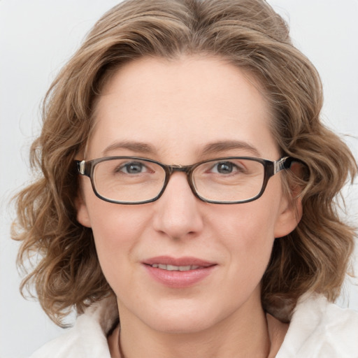 Joyful white adult female with medium  brown hair and blue eyes