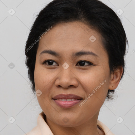 Joyful latino adult female with medium  brown hair and brown eyes