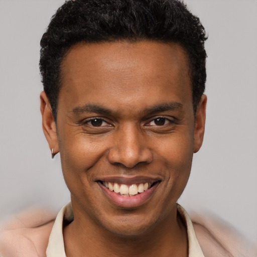 Joyful black young-adult male with short  brown hair and brown eyes