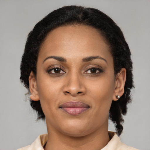 Joyful black young-adult female with medium  black hair and brown eyes