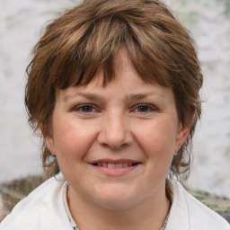 Joyful white adult female with medium  brown hair and brown eyes