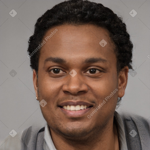 Joyful black young-adult male with short  black hair and brown eyes