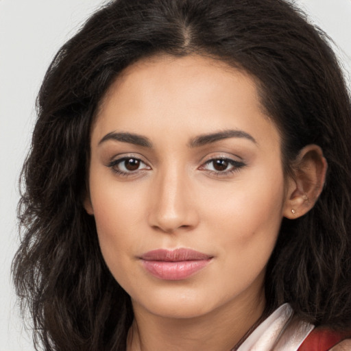 Joyful latino young-adult female with long  brown hair and brown eyes