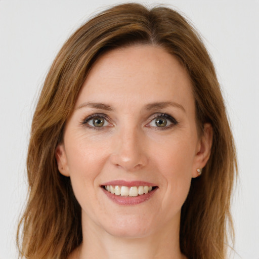 Joyful white young-adult female with long  brown hair and green eyes