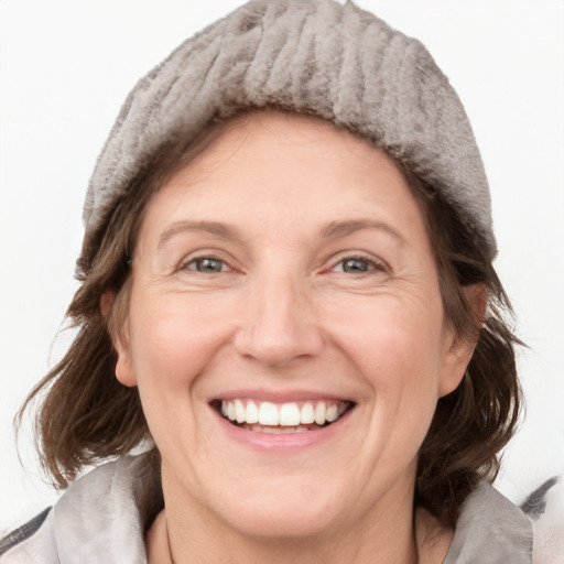 Joyful white adult female with medium  brown hair and blue eyes