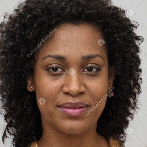 Joyful black young-adult female with long  brown hair and brown eyes